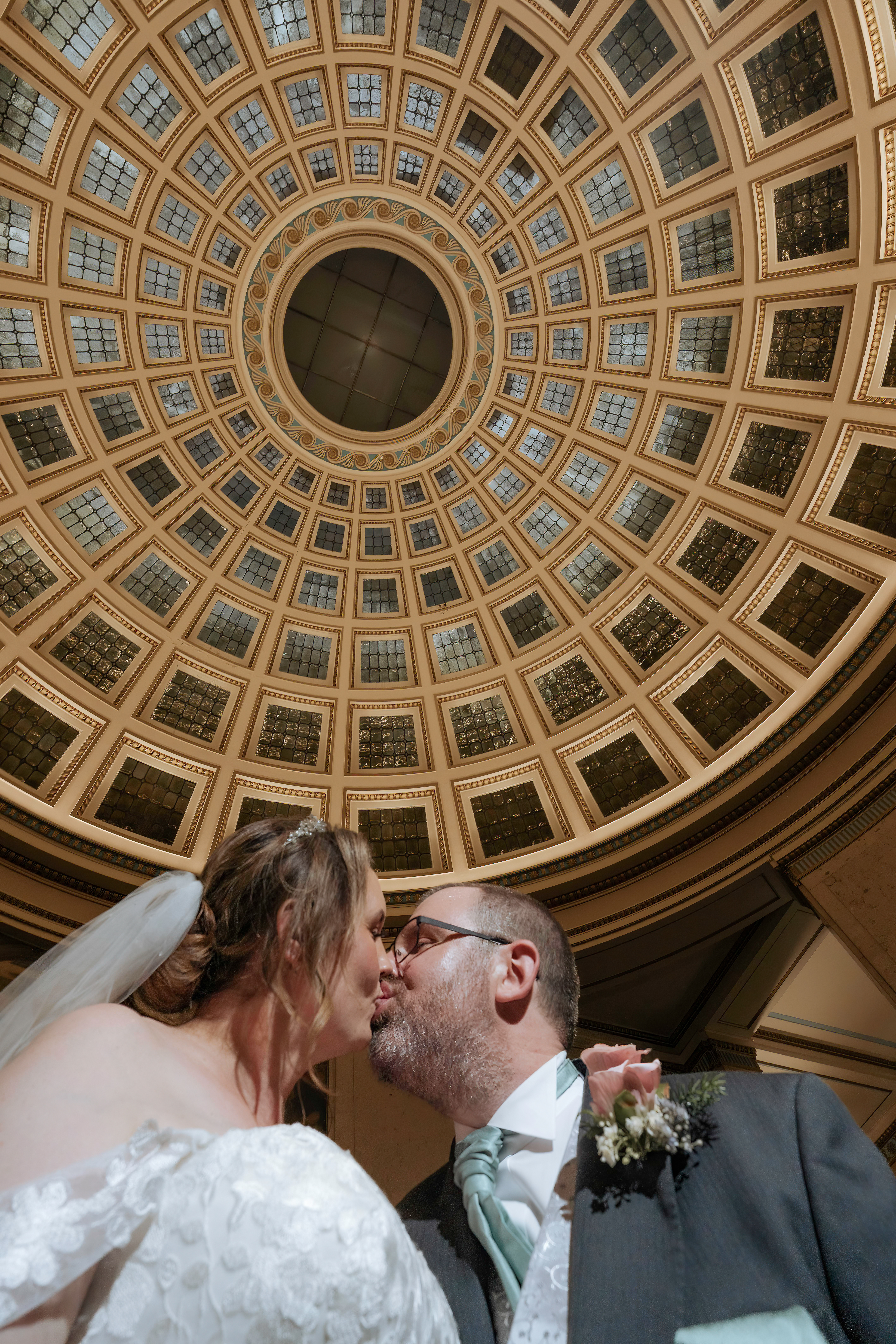 Bride and groom kissing in the nottingham council offices